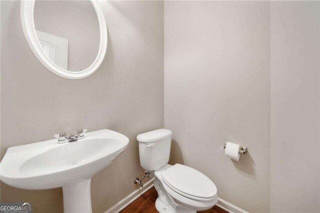 100 Trailside Way, Hiram, GA 30141 - half bathroom with toilet, baseboards, wood finished floors, and a sink