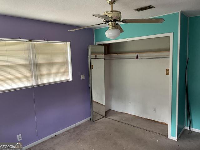 306 Greenview St, Jesup, GA 31545 - unfurnished bedroom with a closet, a textured ceiling, baseboards, and a ceiling fan