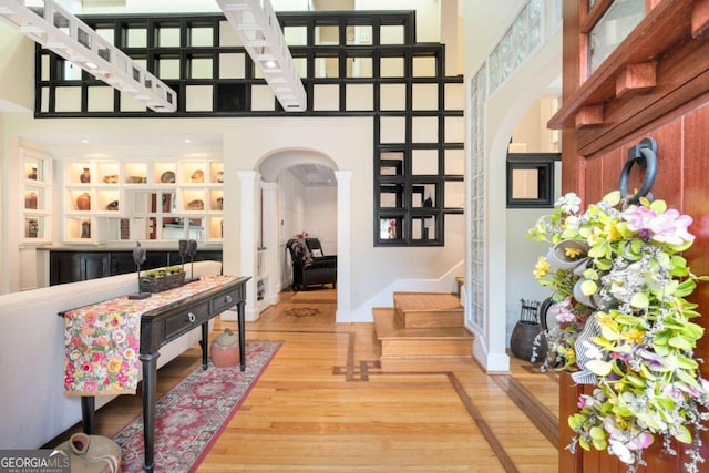 228 Clarion Ave, Decatur, GA 30030 - entryway featuring arched walkways, wood finished floors, stairway, a high ceiling, and decorative columns