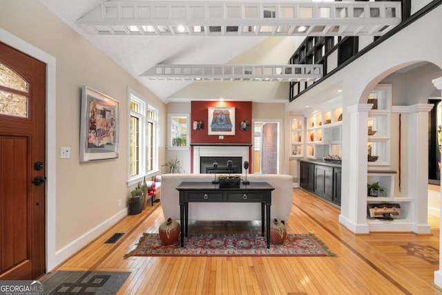 228 Clarion Ave, Decatur, GA 30030 - living area with hardwood / wood-style floors, arched walkways, baseboards, and lofted ceiling