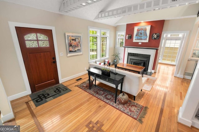228 Clarion Ave, Decatur, GA 30030 - entrance foyer featuring hardwood / wood-style floors, baseboards, a fireplace with flush hearth, and lofted ceiling