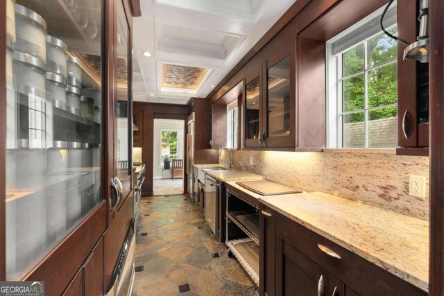 228 Clarion Ave, Decatur, GA 30030 - bar area featuring plenty of natural light, dark stone finish flooring, decorative backsplash, a sink, and coffered ceiling