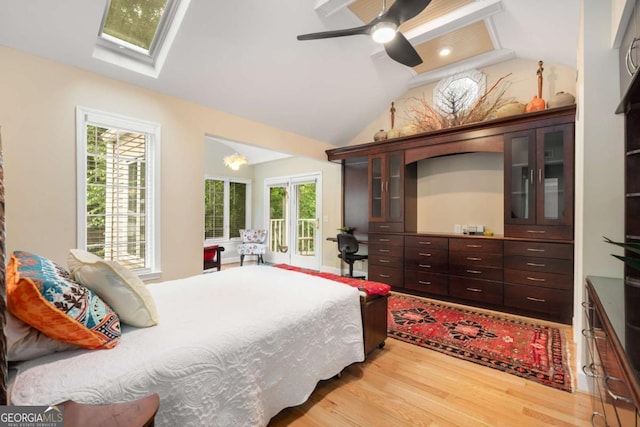 228 Clarion Ave, Decatur, GA 30030 - bedroom featuring wood finished floors, access to outside, vaulted ceiling, a skylight, and ceiling fan