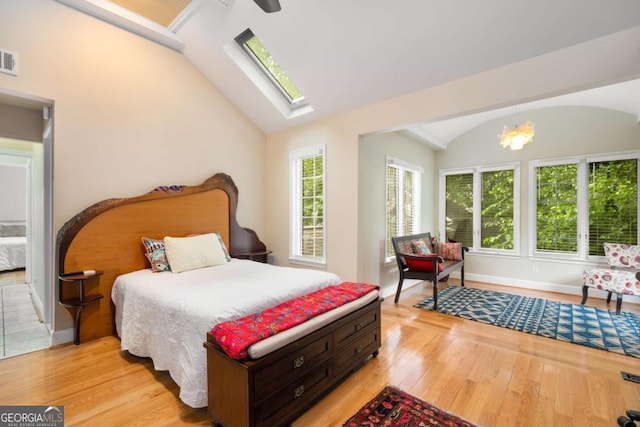 228 Clarion Ave, Decatur, GA 30030 - bedroom featuring vaulted ceiling, light wood-style flooring, a skylight, baseboards, and a ceiling fan