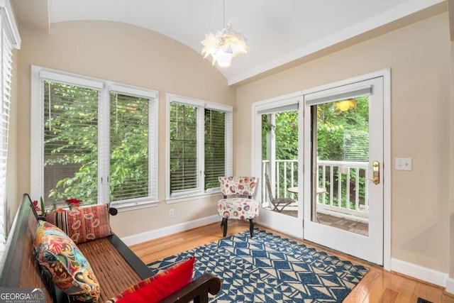 228 Clarion Ave, Decatur, GA 30030 - living area with a chandelier, baseboards, wood finished floors, and lofted ceiling