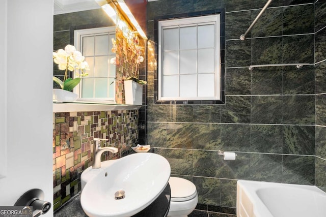 228 Clarion Ave, Decatur, GA 30030 - bathroom with tile walls, a sink, toilet, and crown molding