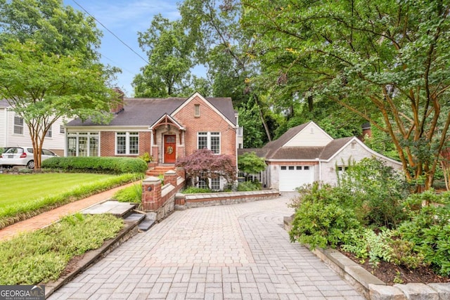 228 Clarion Ave, Decatur, GA 30030 - view of front of house with brick siding, decorative driveway, and a front yard