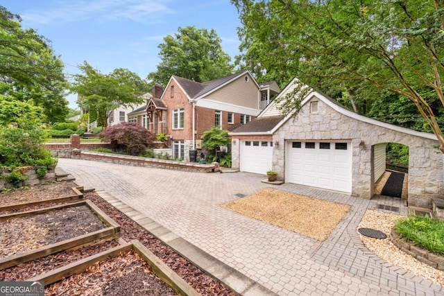 228 Clarion Ave, Decatur, GA 30030 - view of front of house with stone siding, driveway, and an attached garage