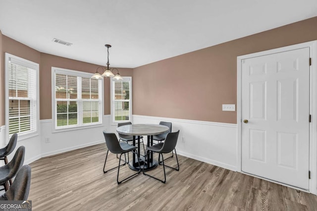 502 Stoneland Pl, Lawrenceville, GA 30046 - dining space featuring wood finished floors, a chandelier, and baseboards