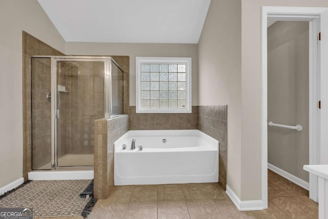 502 Stoneland Pl, Lawrenceville, GA 30046 - full bath with vaulted ceiling, a garden tub, a stall shower, and tile patterned floors