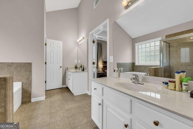 502 Stoneland Pl, Lawrenceville, GA 30046 - full bath featuring two vanities, a garden tub, tile patterned flooring, a stall shower, and baseboards