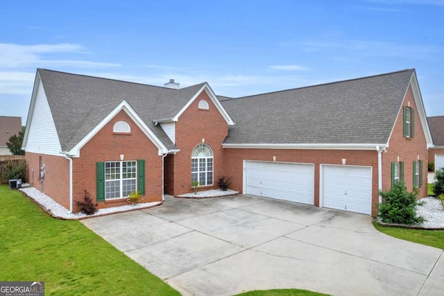 502 Stoneland Pl, Lawrenceville, GA 30046 - view of front of house with brick siding, driveway, an attached garage, and central air condition unit
