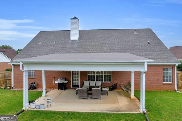 502 Stoneland Pl, Lawrenceville, GA 30046 - rear view of property with a chimney, a patio area, an outdoor hangout area, and brick siding