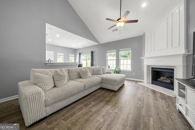 1535 Fenmore St, Lithia Springs, GA 30122 - living room with ceiling fan, lofted ceiling, wood finished floors, a large fireplace, and recessed lighting