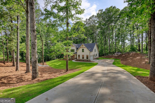 460 Ridge Point Dr, Monticello, GA 31064 - view of front of property featuring driveway, an attached garage, a front lawn, and board and batten siding