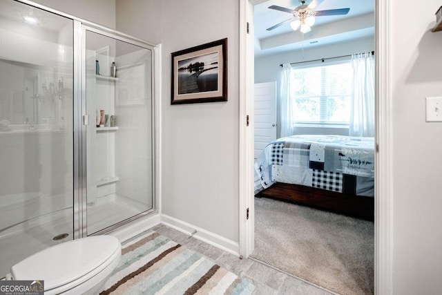 174 Silver Birch Pass, Newnan, GA 30265 - ensuite bathroom with a shower stall, ceiling fan, baseboards, toilet, and a raised ceiling