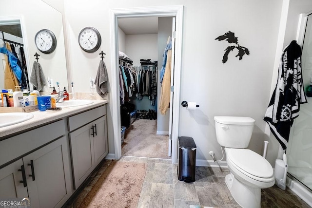 174 Silver Birch Pass, Newnan, GA 30265 - full bath with toilet, a walk in closet, double vanity, stone finish floors, and baseboards