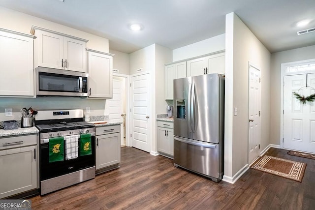 174 Silver Birch Pass, Newnan, GA 30265 - kitchen featuring appliances with stainless steel finishes, dark wood finished floors, baseboards, and light stone counters