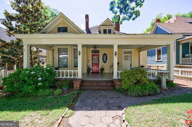 381 Cherokee Ave SE, Atlanta, GA 30312 - view of front facade featuring a chimney and covered porch