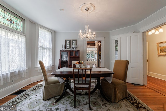 381 Cherokee Ave SE, Atlanta, GA 30312 - dining area with a chandelier, wood finished floors, and ornamental molding