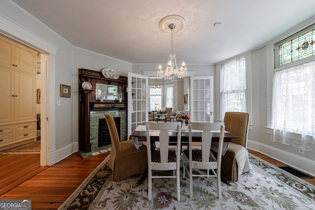 381 Cherokee Ave SE, Atlanta, GA 30312 - dining space with wood finished floors, a chandelier, and ornamental molding