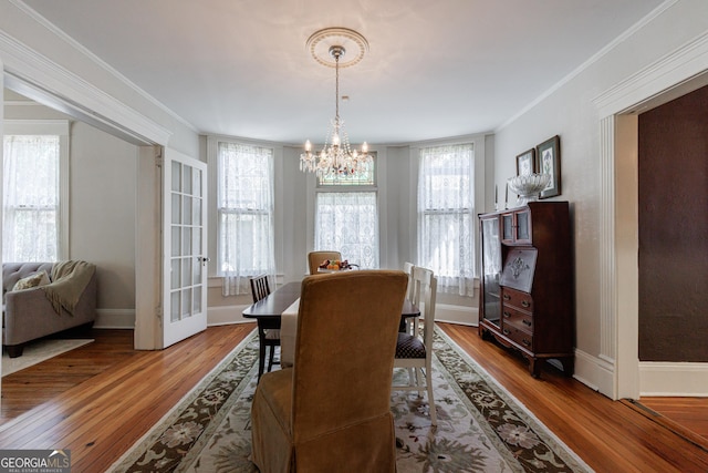 381 Cherokee Ave SE, Atlanta, GA 30312 - dining room featuring a chandelier, plenty of natural light, ornamental molding, and wood finished floors