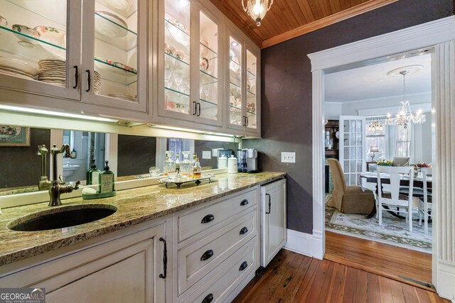 381 Cherokee Ave SE, Atlanta, GA 30312 - bar with ornamental molding, dark wood-style flooring, pendant lighting, and a chandelier