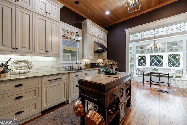 381 Cherokee Ave SE, Atlanta, GA 30312 - kitchen with a chandelier, wooden ceiling, under cabinet range hood, decorative backsplash, and light stone countertops