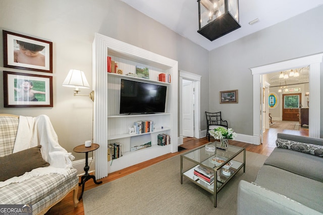 381 Cherokee Ave SE, Atlanta, GA 30312 - living room with wood finished floors, a chandelier, and lofted ceiling