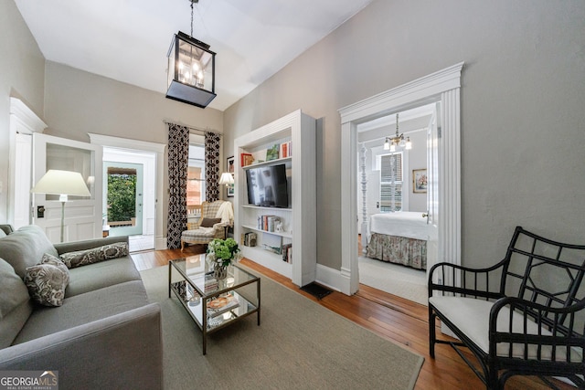 381 Cherokee Ave SE, Atlanta, GA 30312 - living area with a chandelier and wood finished floors
