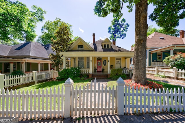 381 Cherokee Ave SE, Atlanta, GA 30312 - view of front of house with a porch, a chimney, and a fenced front yard