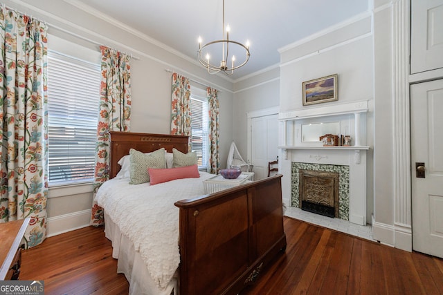 381 Cherokee Ave SE, Atlanta, GA 30312 - bedroom with hardwood / wood-style flooring, a chandelier, multiple windows, ornamental molding, and a fireplace