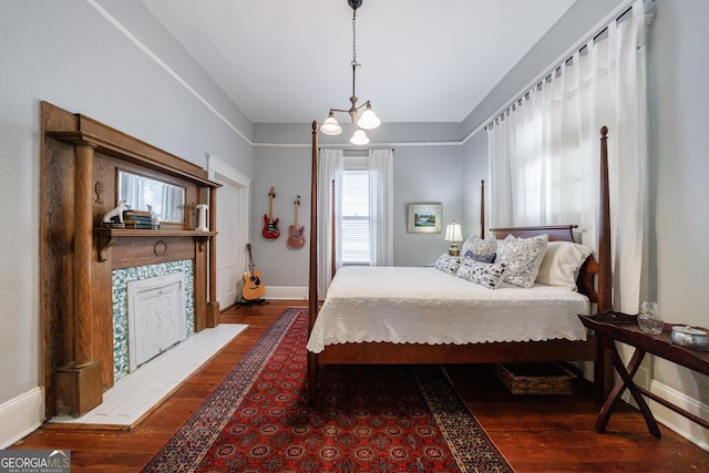 381 Cherokee Ave SE, Atlanta, GA 30312 - bedroom with dark wood-type flooring and a tiled fireplace