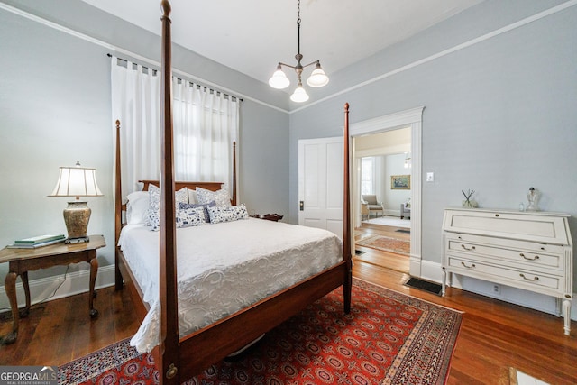 381 Cherokee Ave SE, Atlanta, GA 30312 - bedroom with wood finished floors, multiple windows, and a chandelier