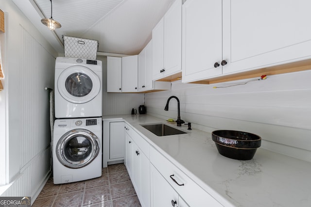 381 Cherokee Ave SE, Atlanta, GA 30312 - laundry area with stacked washer / drying machine, cabinet space, and tile patterned floors