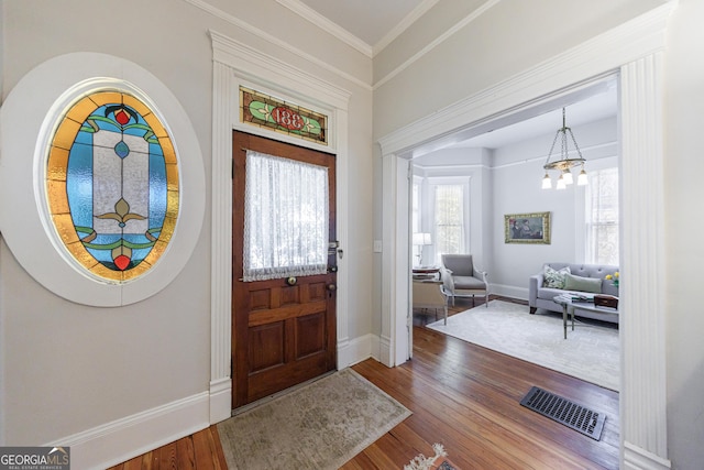 381 Cherokee Ave SE, Atlanta, GA 30312 - foyer with wood finished floors, a chandelier, and ornamental molding