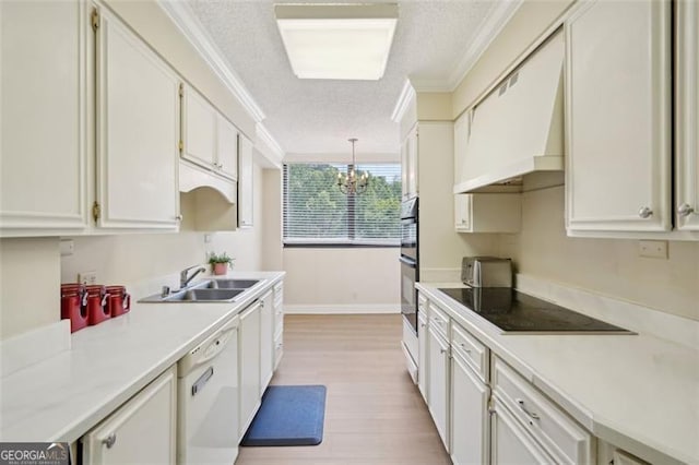 3530 Piedmont Rd NE Unit 2I, Atlanta, GA 30305 - kitchen with black appliances, a textured ceiling, a chandelier, ornamental molding, and light countertops