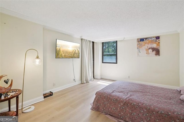 3530 Piedmont Rd NE Unit 2I, Atlanta, GA 30305 - bedroom with a textured ceiling, wood finished floors, and ornamental molding