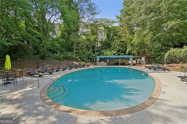 3530 Piedmont Rd NE Unit 2I, Atlanta, GA 30305 - community pool with a patio area and view of scattered trees