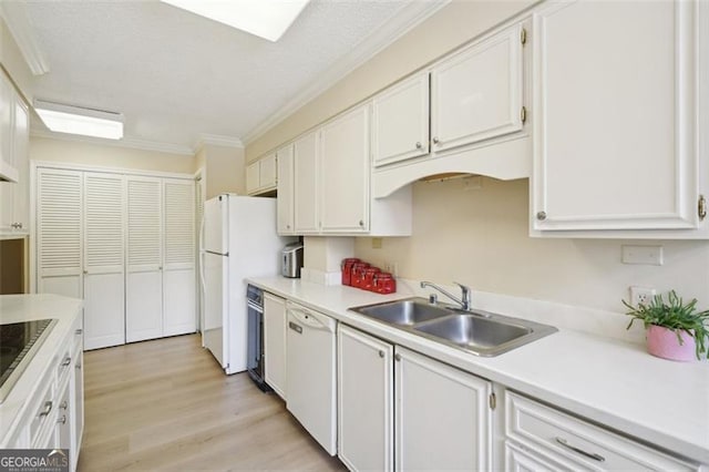 3530 Piedmont Rd NE Unit 2I, Atlanta, GA 30305 - kitchen with white appliances, white cabinets, light countertops, ornamental molding, and light wood-style floors