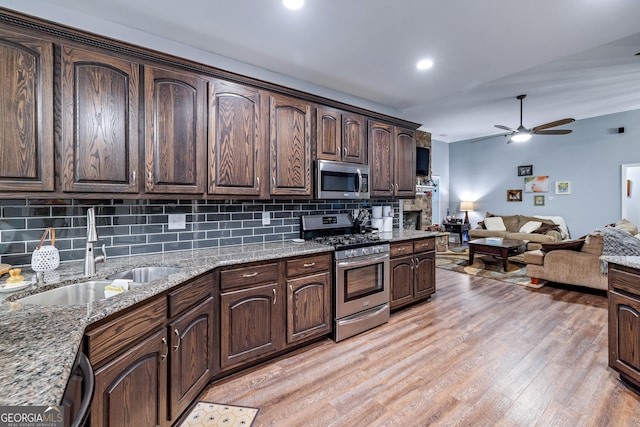 405 Dugas Rd, Dahlonega, GA 30533 - kitchen with stainless steel appliances, a sink, decorative backsplash, a ceiling fan, and dark brown cabinets