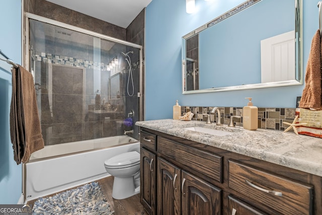 405 Dugas Rd, Dahlonega, GA 30533 - bathroom featuring vanity, toilet, wood finished floors, combined bath / shower with glass door, and decorative backsplash