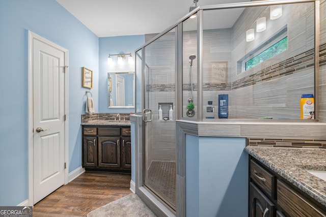 405 Dugas Rd, Dahlonega, GA 30533 - full bathroom featuring vanity, a stall shower, and wood finished floors