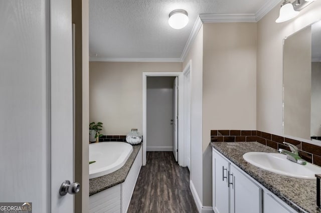 131 Bob White Ln, Newnan, GA 30263 - full bath featuring ornamental molding, vanity, a garden tub, wood finished floors, and decorative backsplash