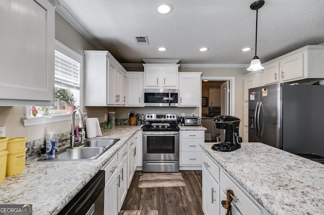 131 Bob White Ln, Newnan, GA 30263 - kitchen featuring appliances with stainless steel finishes, crown molding, white cabinets, dark wood-type flooring, and recessed lighting