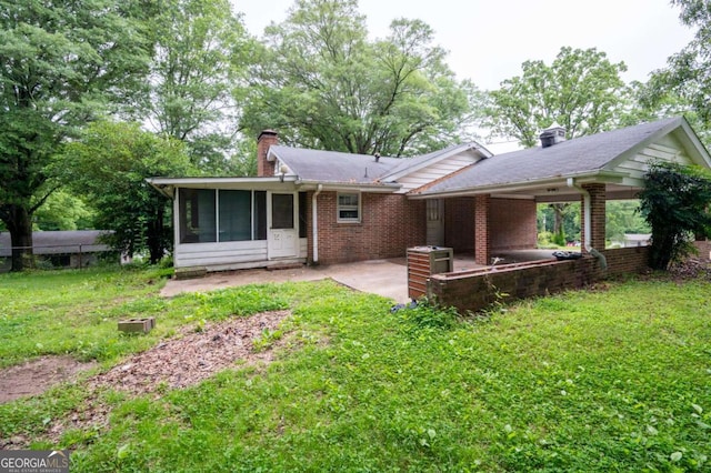 1395 Clay Rd SW, Mableton, GA 30126 - back of house featuring a patio area, a chimney, a sunroom, a lawn, and brick siding