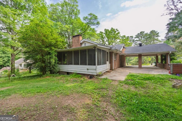 1395 Clay Rd SW, Mableton, GA 30126 - rear view of property featuring an attached carport, a sunroom, and a chimney