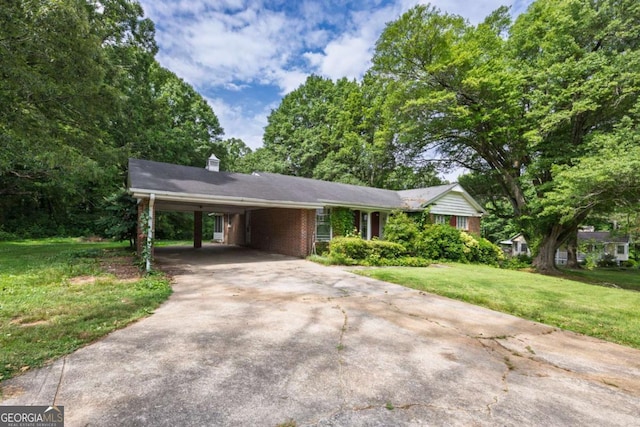 1395 Clay Rd SW, Mableton, GA 30126 - ranch-style house featuring driveway, a front lawn, a carport, brick siding, and a chimney