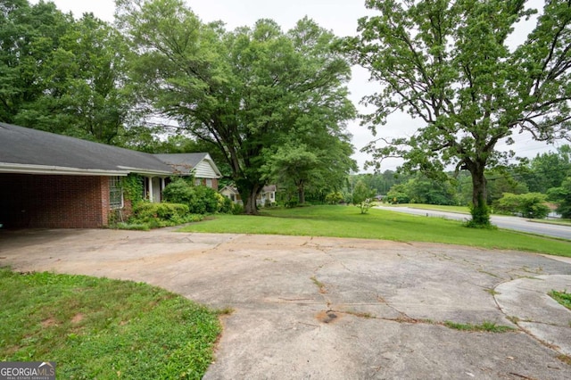 1395 Clay Rd SW, Mableton, GA 30126 - view of green lawn with concrete driveway and a carport