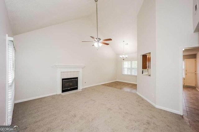 4112 Meadowlark Ct, Powder Springs, GA 30127 - unfurnished living room with ceiling fan, carpet, high vaulted ceiling, a tiled fireplace, and baseboards